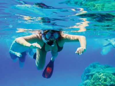 snorkeler in shallow waters of three rocks Sosua
