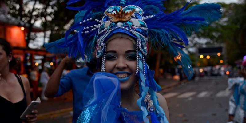 woman with feathered hat at carnival