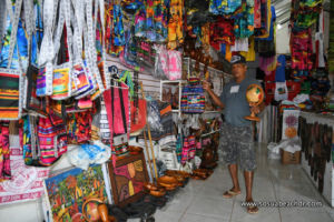 Daniel showing the store merchandise